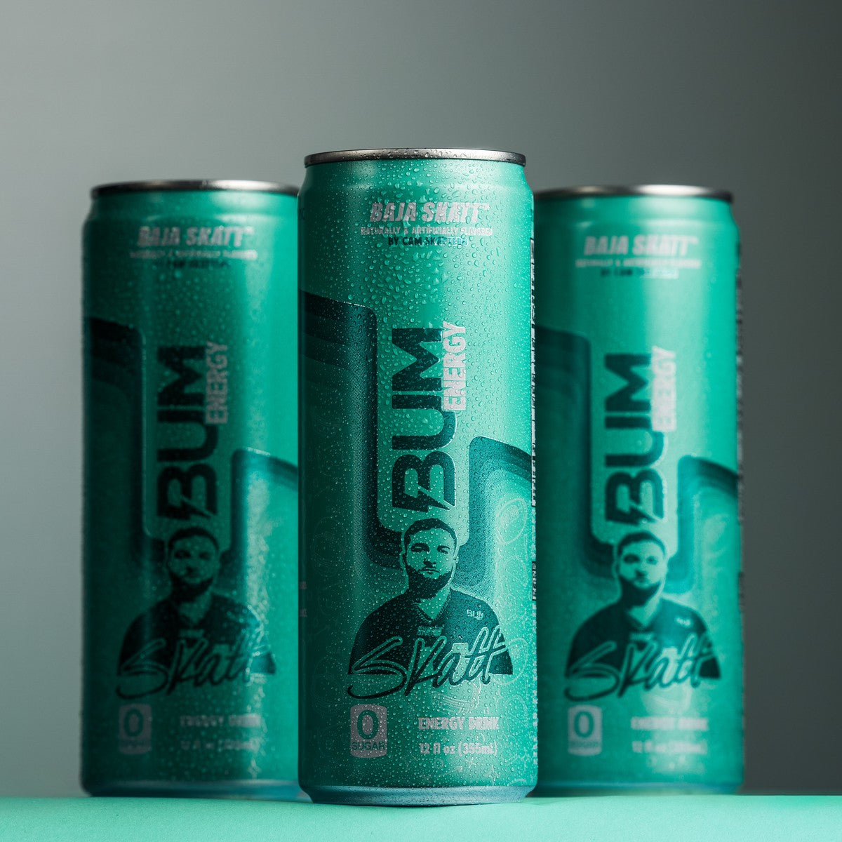 Three cans of BUM Energy's Baja Skatt flavor energy drink, a zero sugar collab with Cam Skattebo