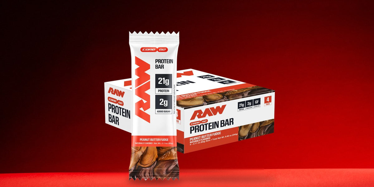 RAW Core Peanut Butter Fudge Protein Bar 4-pack box with a single bar in front, on a red background.