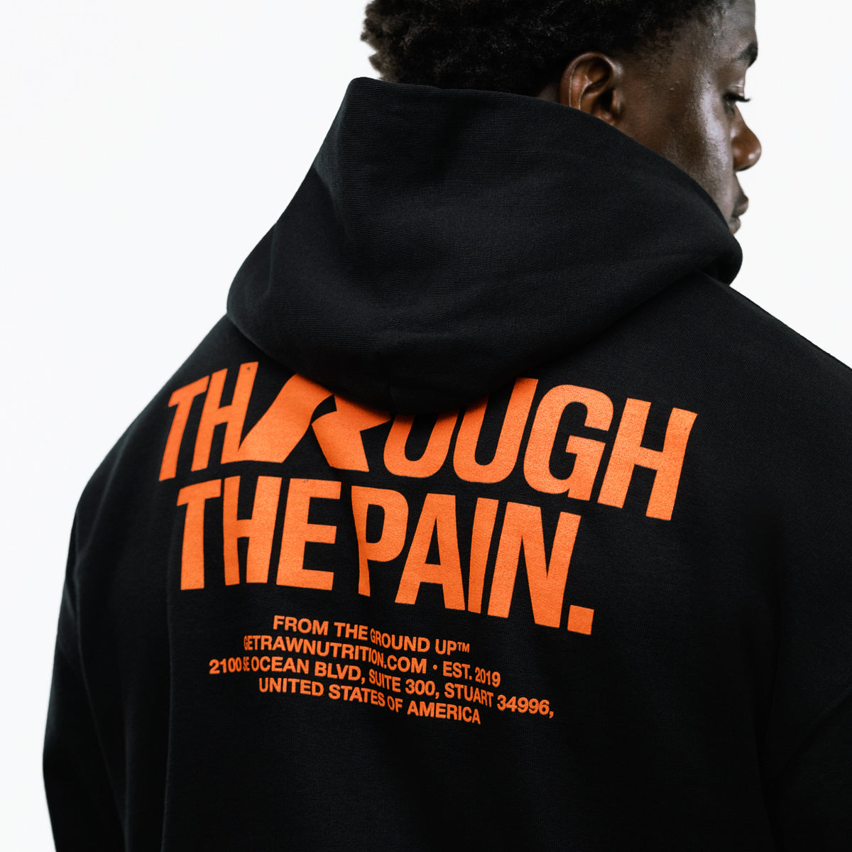 RAW Core Through The Pain Hoodie, black and orange, back graphic detail on model