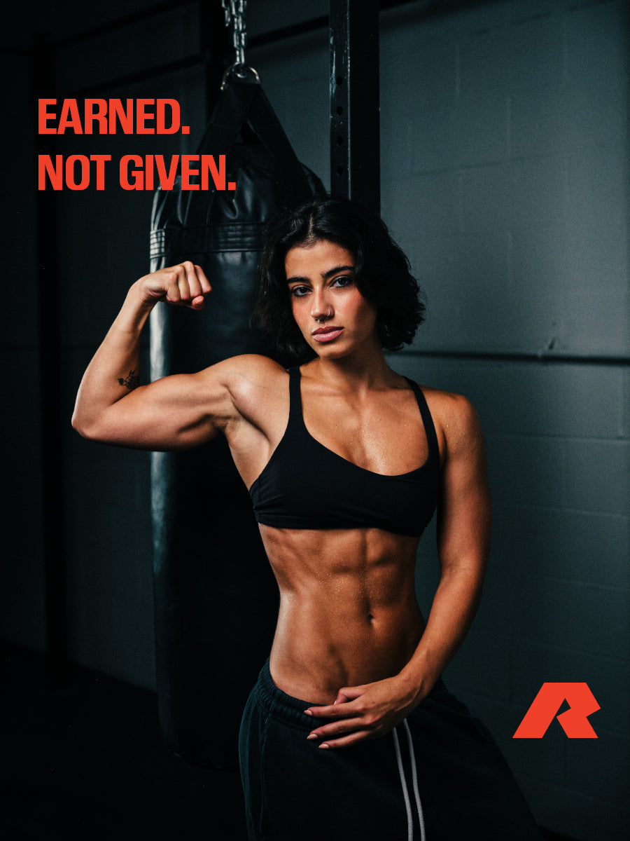 Earned. Not given. Sara Saffari flexing beside a punching bag