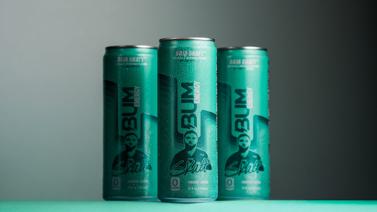 BUM Energy Baja Skatt flavor, three cans on a teal background
