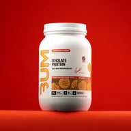 BUM Itholate Protein Peanut Butter Cookie tub on a red background.