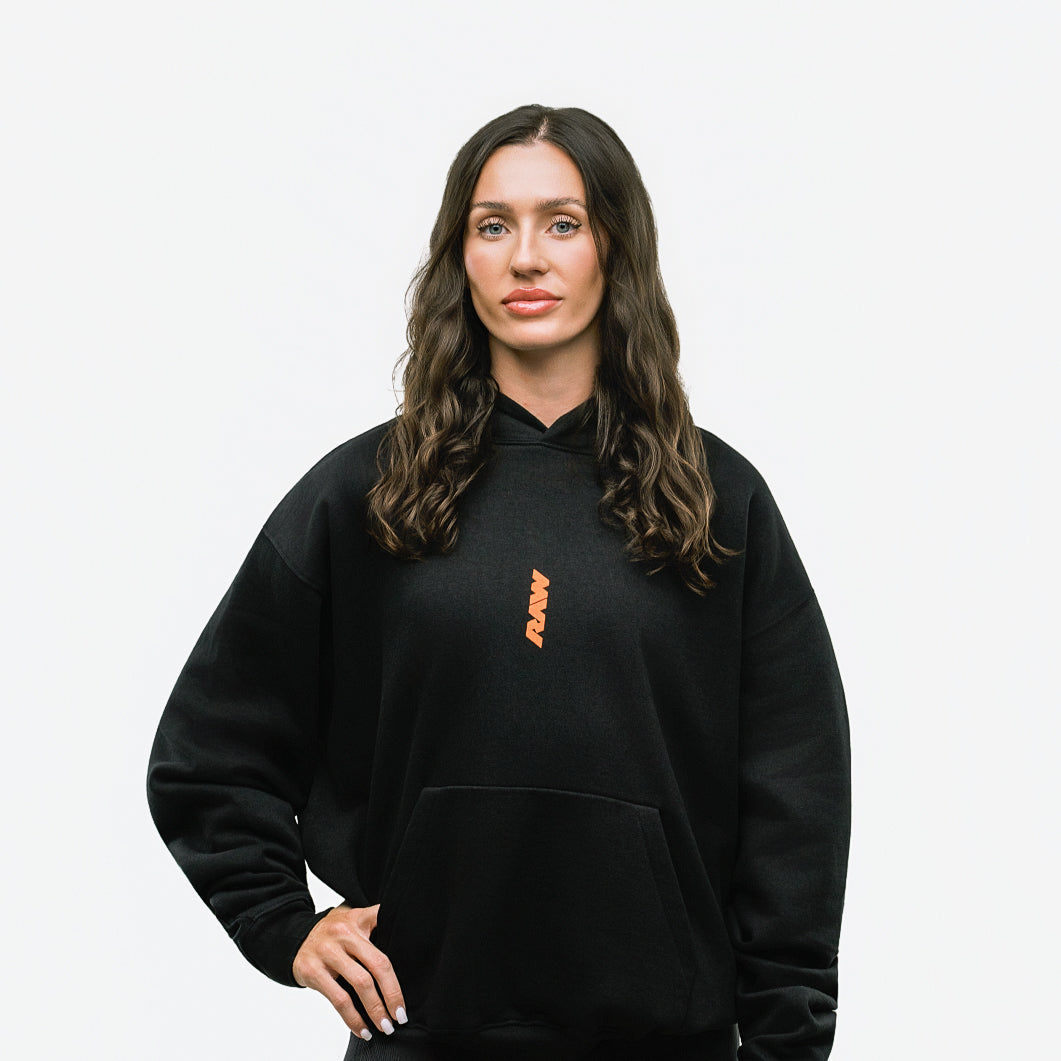 RAW Core Through The Pain Hoodie, black and orange, on model, front (women's)