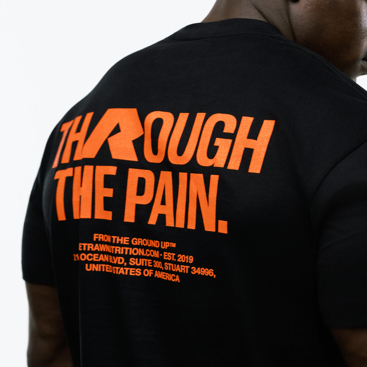 RAW Core Through The Pain T-Shirt, black and orange, back graphic detail on model