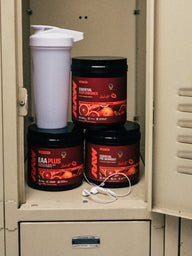 Sara Saffari Sour Blood Orange EAA Plus, Essential Performance and Essential Pre-Workout in a gym locker with a shaker